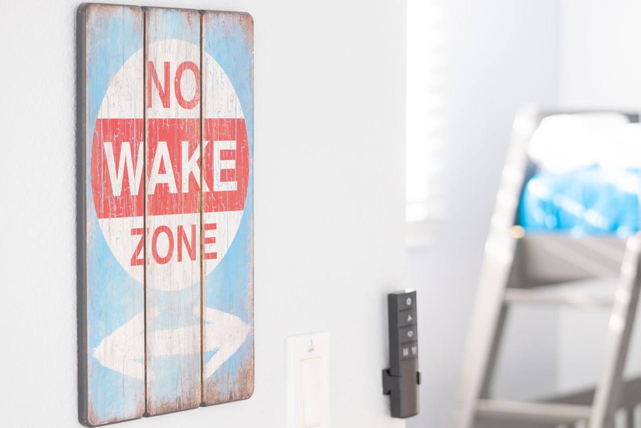 Bunk room detail: a playful No Wake Zone sign by the door